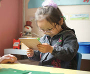 Image of a child looking at a book